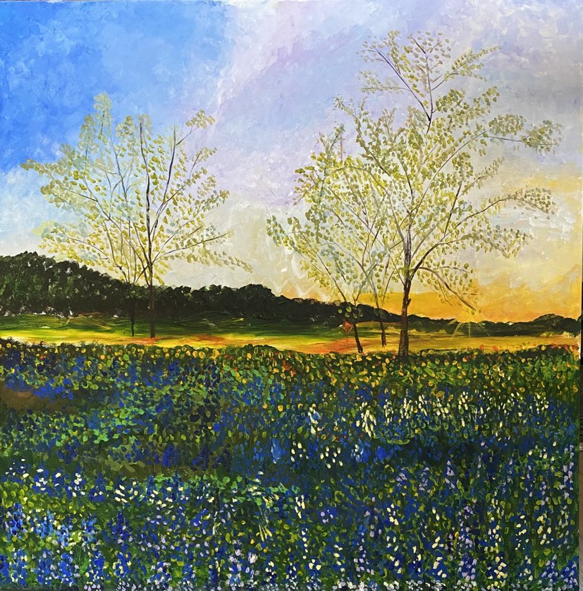 Trees and bluebonnets in a field